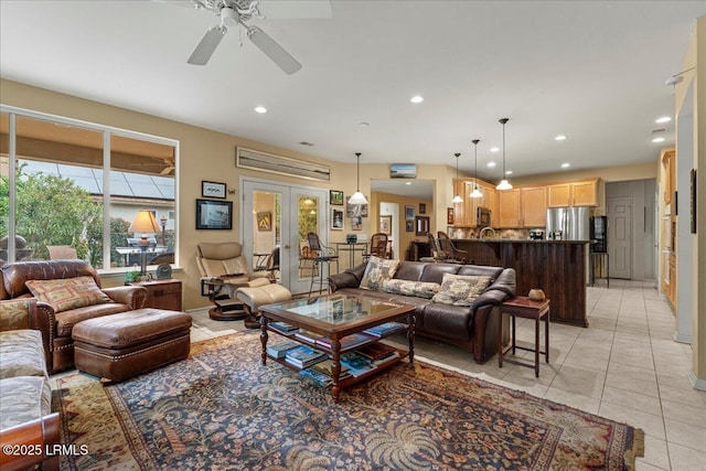 living area featuring light tile patterned floors, recessed lighting, ceiling fan, and french doors