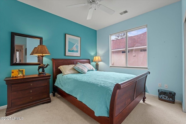 bedroom with visible vents, ceiling fan, light carpet, and baseboards