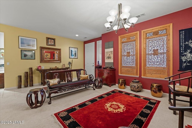 sitting room featuring visible vents, carpet flooring, and an inviting chandelier