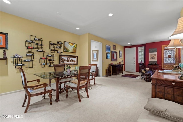 dining room with light carpet, baseboards, and recessed lighting