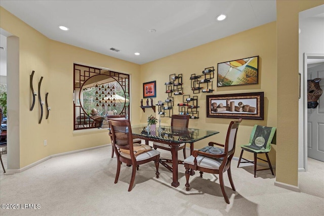 dining room featuring recessed lighting, visible vents, and light colored carpet