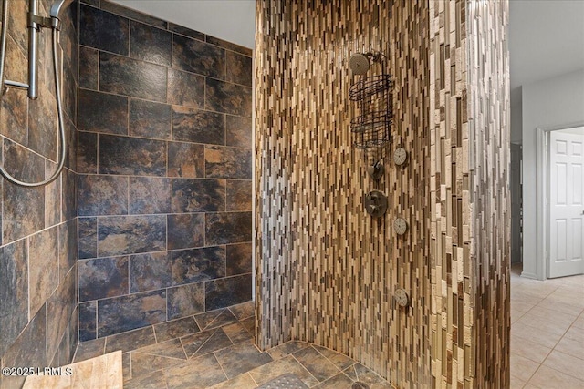 bathroom featuring stone finish floor and a tile shower