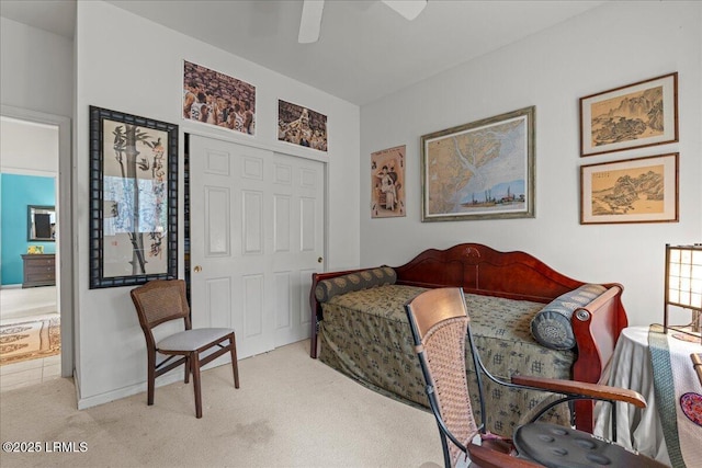 bedroom with a ceiling fan and light colored carpet