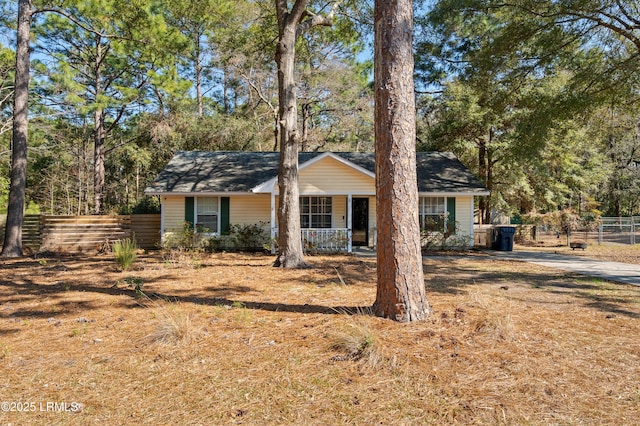 view of front of property with fence and a porch