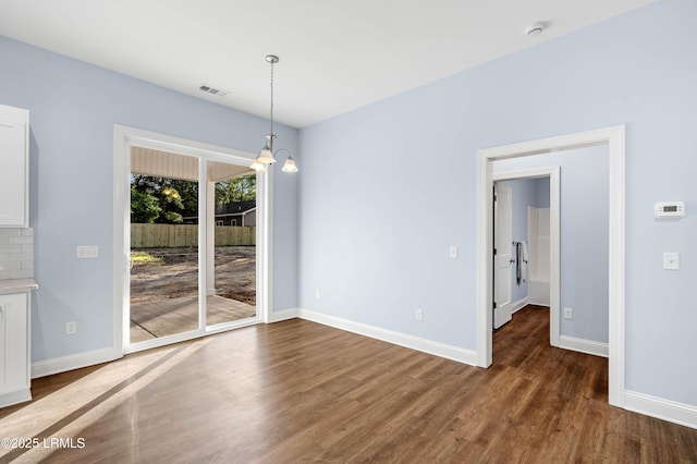 95 Salkehatchie Rd, Yemassee, SC 29945 - unfurnished dining area featuring dark wood-type flooring, baseboards, and a chandelier
