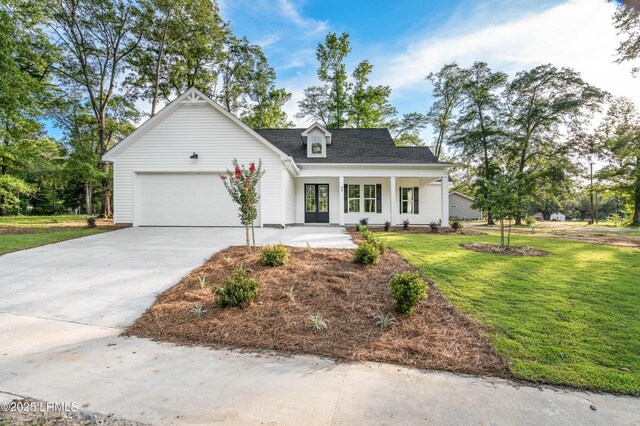 95 Salkehatchie Rd, Yemassee, SC 29945 - view of front of home with a garage, a front yard, driveway, and covered porch