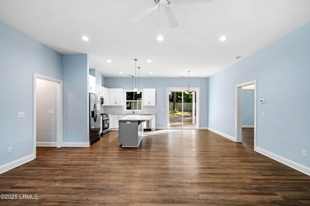 95 Salkehatchie Rd, Yemassee, SC 29945 - kitchen featuring stainless steel appliances, a kitchen island, open floor plan, white cabinets, and a sink