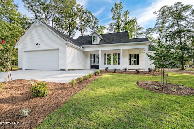 95 Salkehatchie Rd, Yemassee, SC 29945 - view of front of house featuring a garage, driveway, a front yard, a shingled roof, and french doors