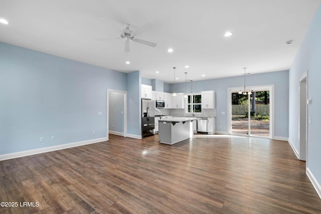 95 Salkehatchie Rd, Yemassee, SC 29945 - unfurnished living room with ceiling fan, baseboards, dark wood finished floors, recessed lighting, and a chandelier