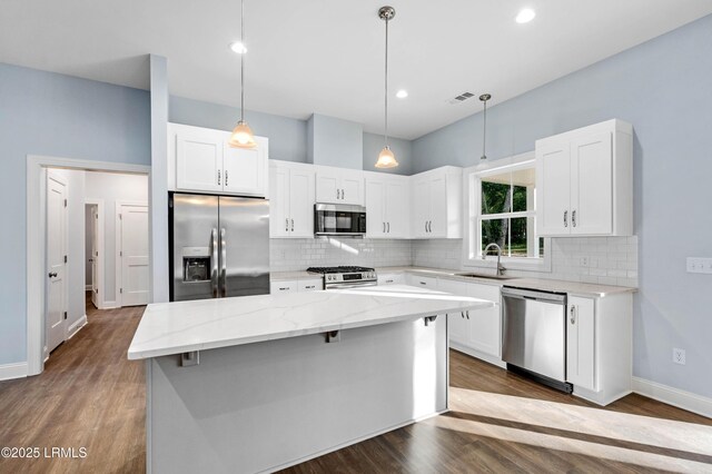 95 Salkehatchie Rd, Yemassee, SC 29945 - kitchen featuring stainless steel appliances, a center island, backsplash, light stone countertops, and recessed lighting