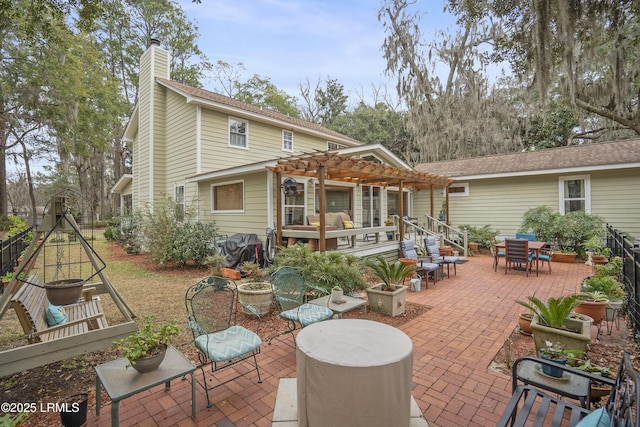 back of house with a patio area, a chimney, and a pergola