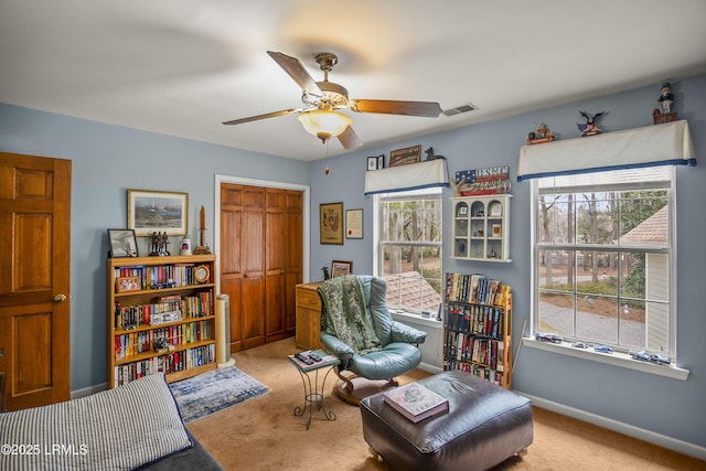 sitting room with a ceiling fan, carpet flooring, baseboards, and visible vents