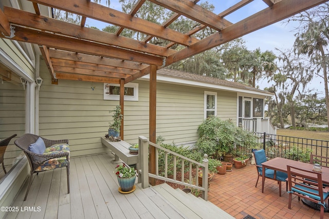 deck with outdoor dining area and a pergola