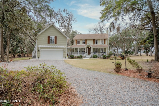 view of front of property with an attached garage, a front yard, covered porch, a chimney, and driveway