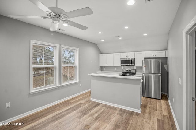 kitchen with white cabinetry, light countertops, baseboards, and stainless steel appliances