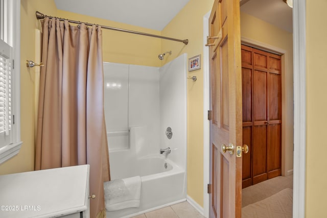 bathroom with tile patterned flooring and shower / tub combo