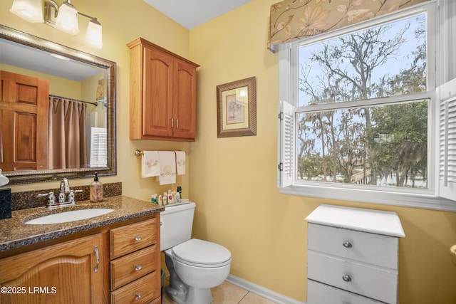 bathroom with tile patterned floors, toilet, a shower with shower curtain, baseboards, and vanity