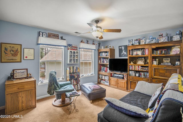 carpeted living area featuring baseboards, visible vents, and ceiling fan