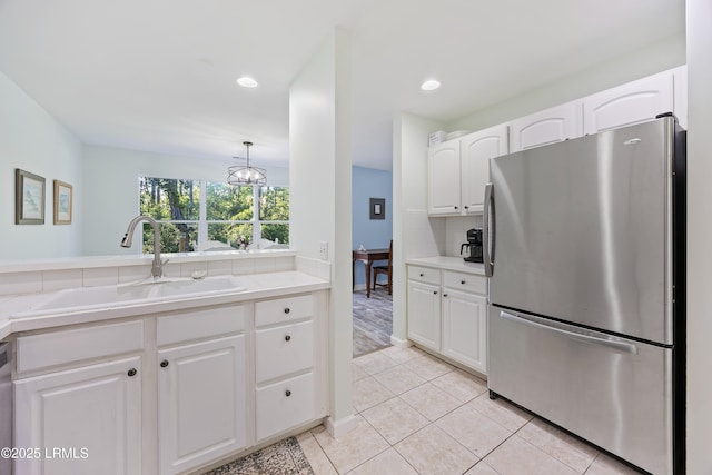 52 Lake Linden Ln Unit 52, Bluffton, SC 29910 - kitchen with freestanding refrigerator, white cabinetry, light countertops, light tile patterned floors, and recessed lighting