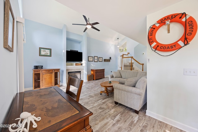 52 Lake Linden Ln Unit 52, Bluffton, SC 29910 - living room featuring wood finished floors, a fireplace, ceiling fan, vaulted ceiling, and stairs