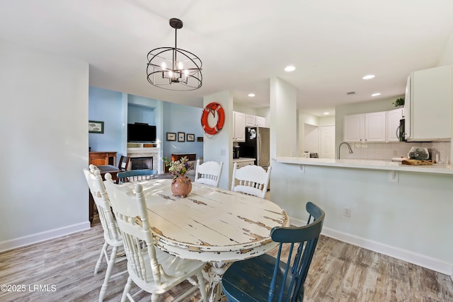 52 Lake Linden Ln Unit 52, Bluffton, SC 29910 - dining area featuring a chandelier, light wood finished floors, a fireplace, and recessed lighting