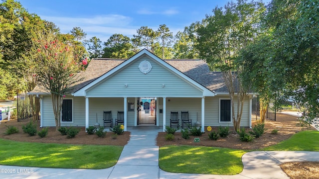 52 Lake Linden Ln Unit 52, Bluffton, SC 29910 - view of front facade with a porch, a front lawn, and roof with shingles
