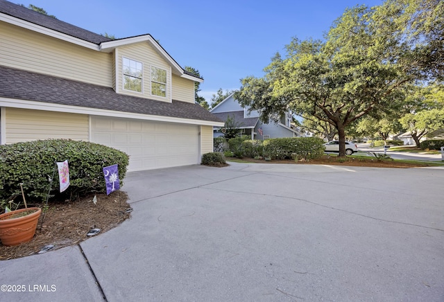 52 Lake Linden Ln Unit 52, Bluffton, SC 29910 - view of side of property featuring an attached garage, concrete driveway, and roof with shingles