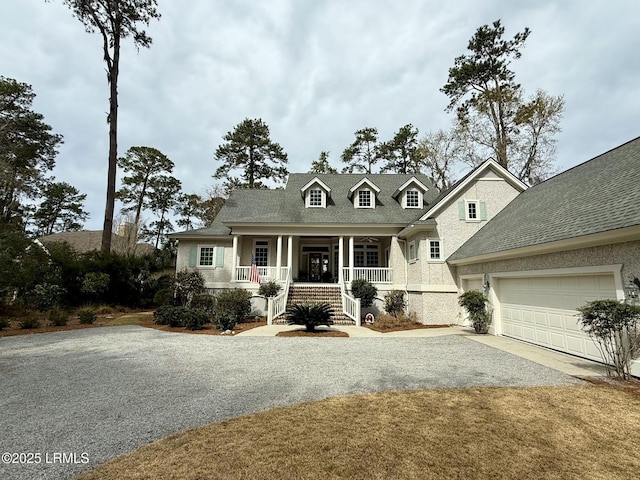 view of front of home with covered porch, driveway, and a garage