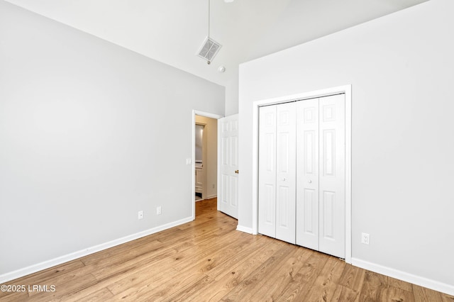 5 Susan Ct, Beaufort, SC 29907 - unfurnished bedroom with wood finished floors, high vaulted ceiling, baseboards, and a closet