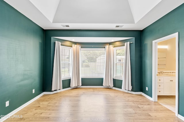 5 Susan Ct, Beaufort, SC 29907 - spare room featuring wood finished floors, lofted ceiling, a sink, and baseboards
