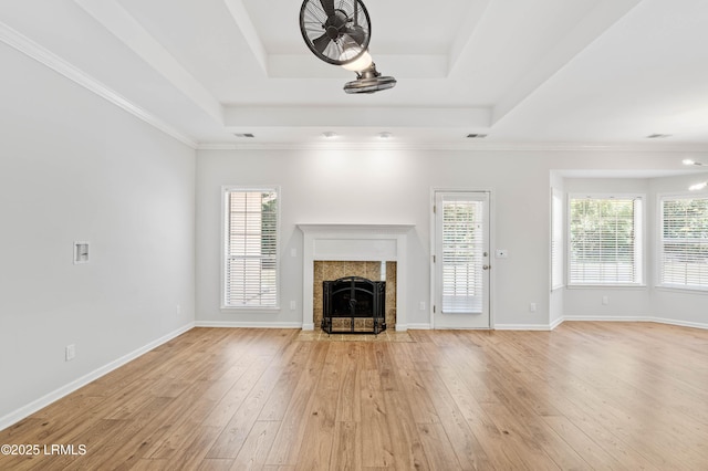 5 Susan Ct, Beaufort, SC 29907 - unfurnished living room featuring a raised ceiling, light wood finished floors, a tiled fireplace, and baseboards