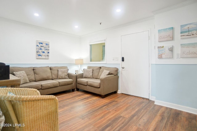 living room with wood-type flooring and ornamental molding