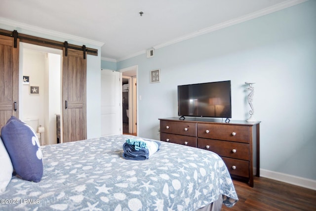 bedroom with crown molding, a barn door, and dark wood-type flooring