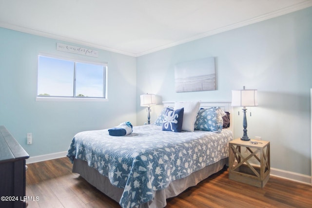 bedroom with crown molding and dark wood-type flooring