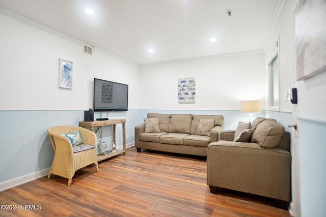 living room featuring hardwood / wood-style flooring and ornamental molding