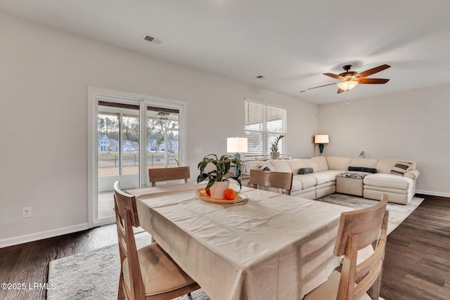 dining room featuring a healthy amount of sunlight, dark hardwood / wood-style floors, and ceiling fan