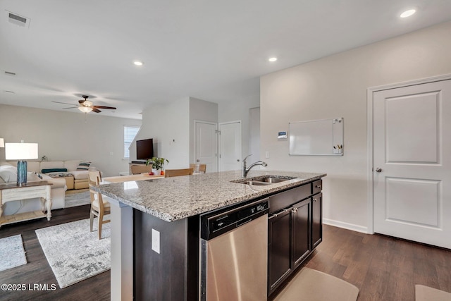 kitchen with sink, dishwasher, ceiling fan, dark hardwood / wood-style floors, and an island with sink