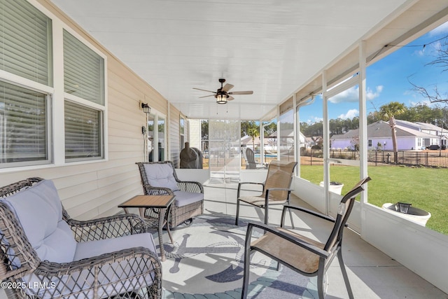 sunroom with ceiling fan