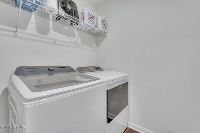 clothes washing area featuring independent washer and dryer