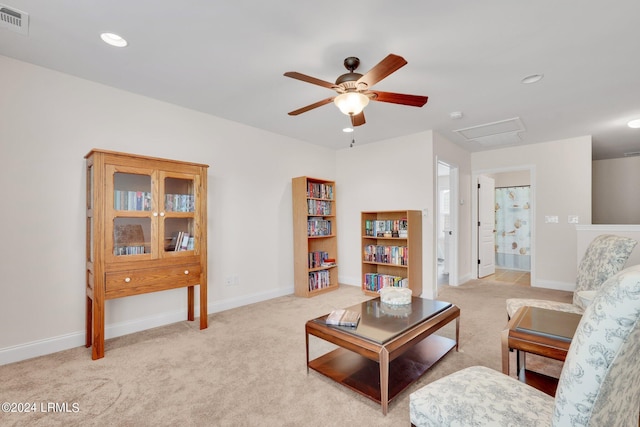 carpeted living room featuring ceiling fan