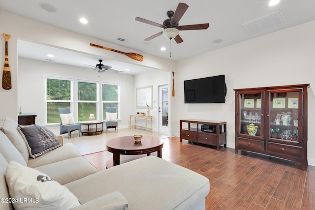 living room featuring hardwood / wood-style floors and ceiling fan