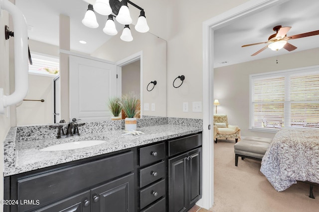 bathroom featuring vanity and ceiling fan with notable chandelier