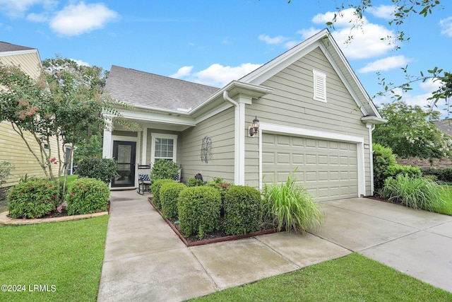 view of front of property featuring a garage and a front yard