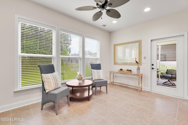 sitting room featuring light tile patterned flooring and ceiling fan