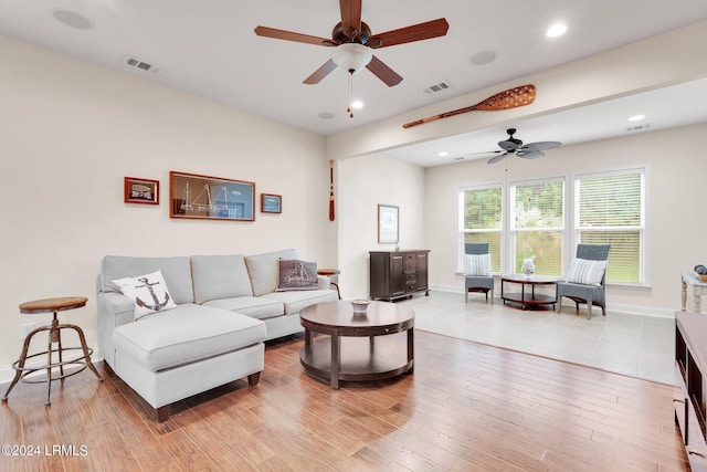 living room with ceiling fan and light hardwood / wood-style floors