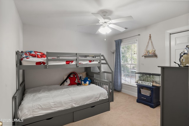 bedroom featuring light colored carpet and ceiling fan