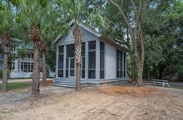 view of outdoor structure with a sunroom