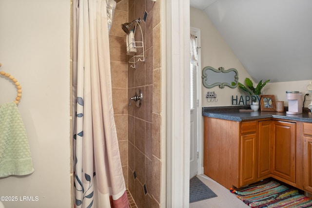 bathroom featuring vaulted ceiling and walk in shower