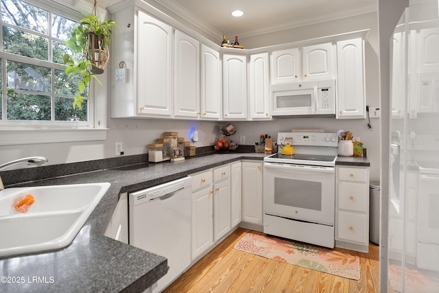 kitchen featuring white cabinetry, white appliances, and sink