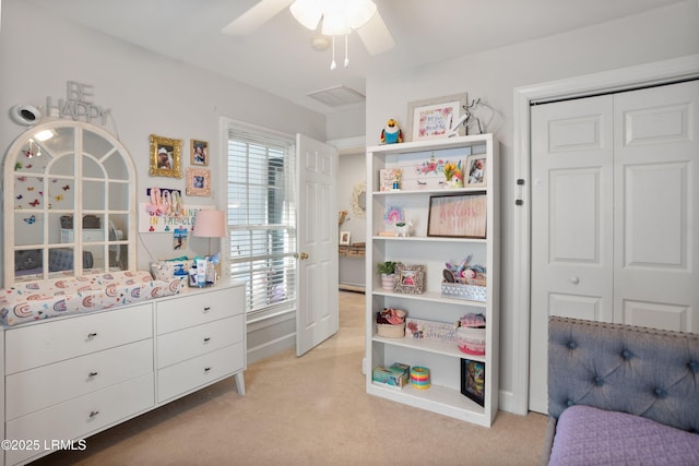 bedroom with multiple windows, ceiling fan, and a closet